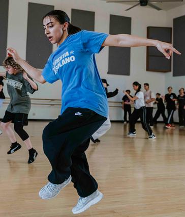 A female student learns street dancing moves in the Dance Center