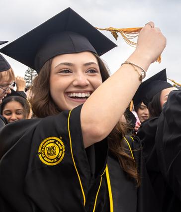 A graduate in regalia turning her tassle