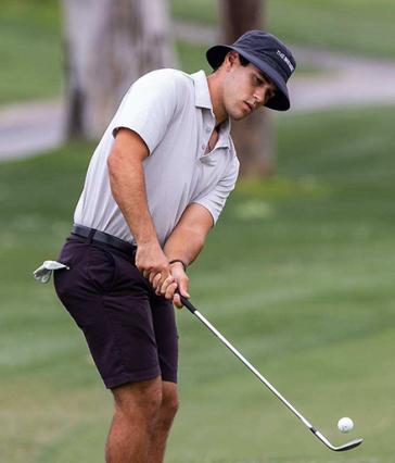 Alejandro de Castro '26 swings a golf club