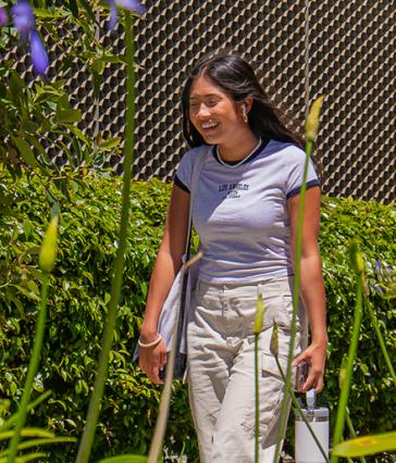 A student walking and smiling