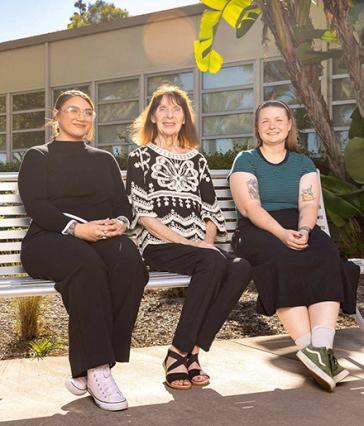 Charlotte Hamilton, Barbara Ellis and Raven Moon sitting on a bench