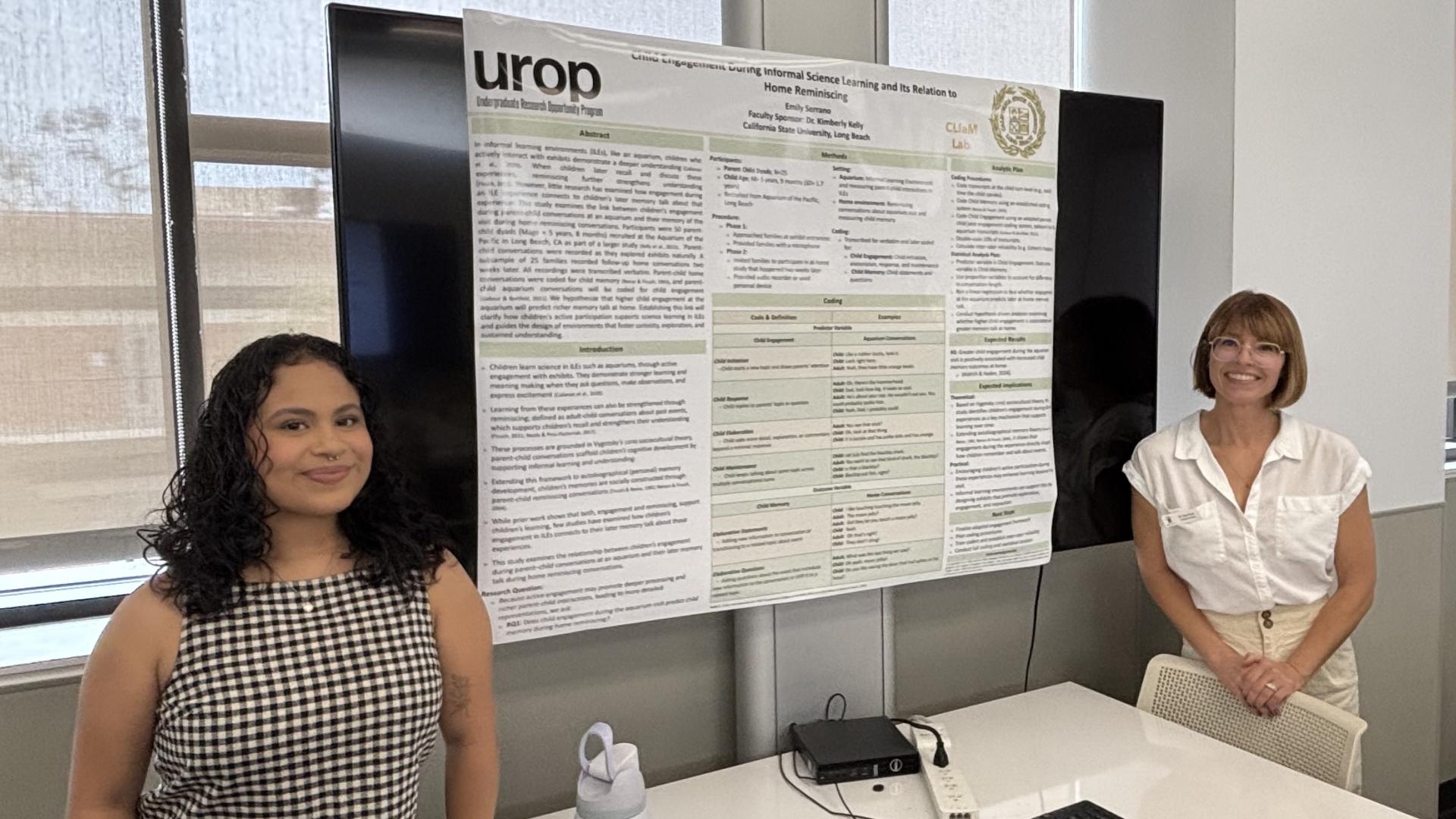 Student Serrano and Dr. Kelly in front of student research poster