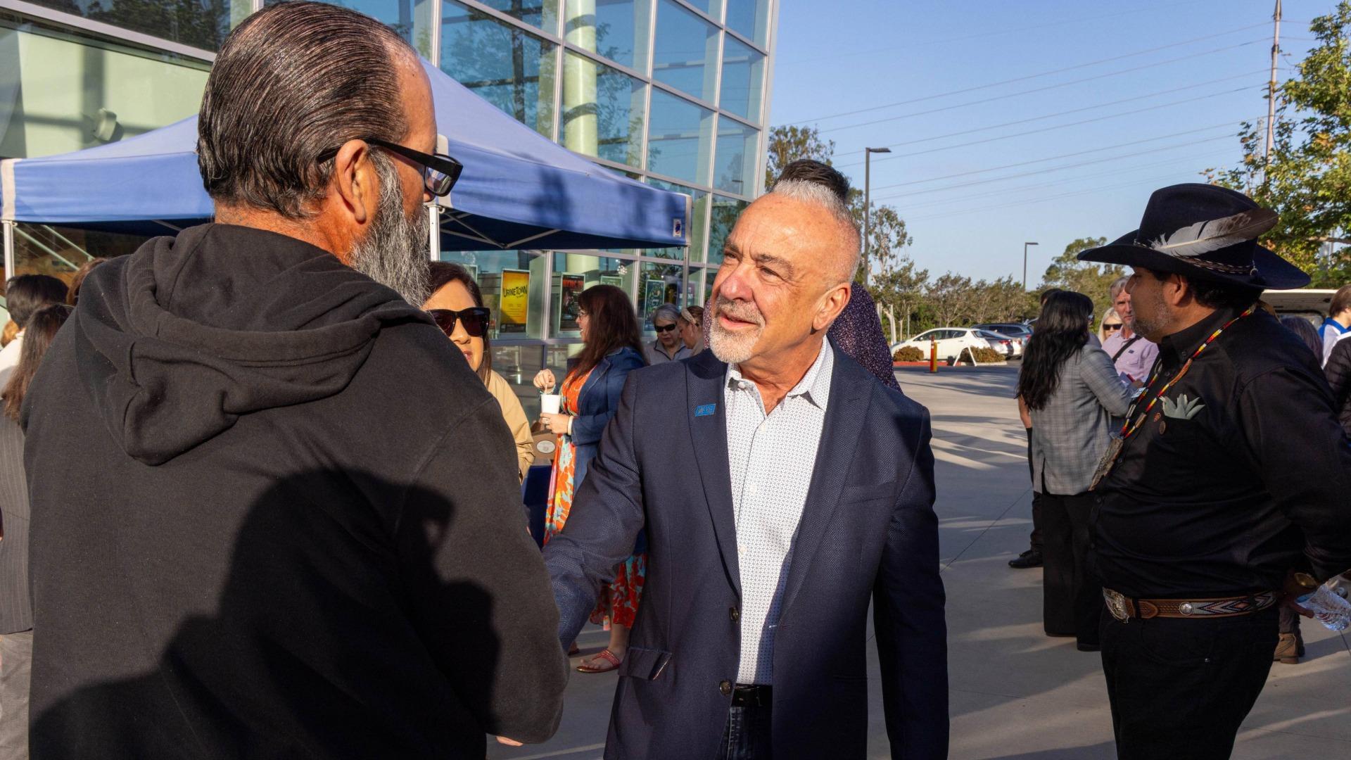 John Hernandez speaks to a staff member at Irvine Valley College