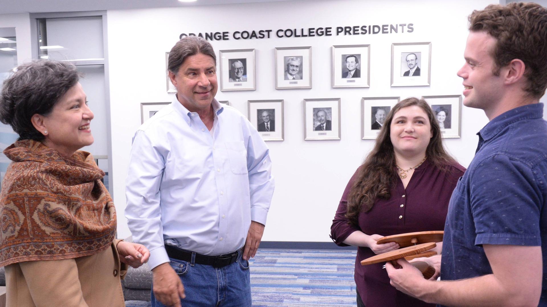 Angelica Suarez, left, talks to colleagues at Orange Coast College