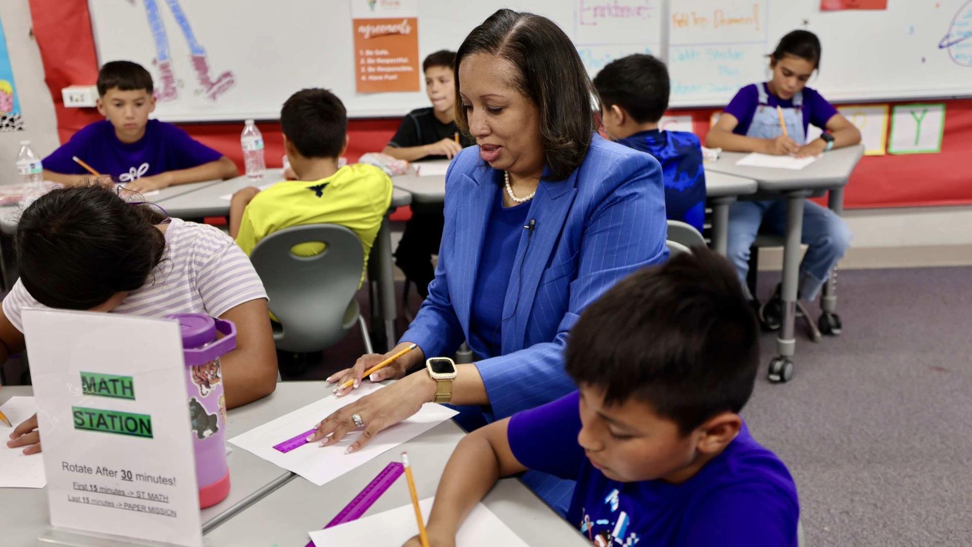 Erin Simon, center, participates in a class activity in a Bellflower school