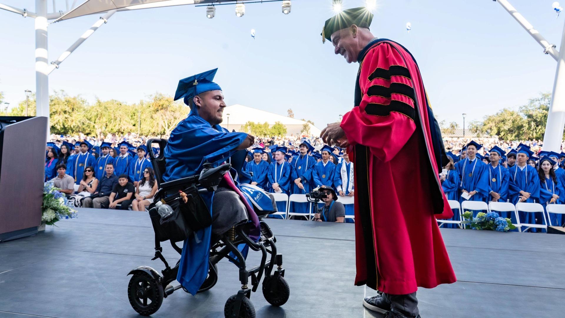 President John Hernandez gives a graduation award at Irvine Valley College