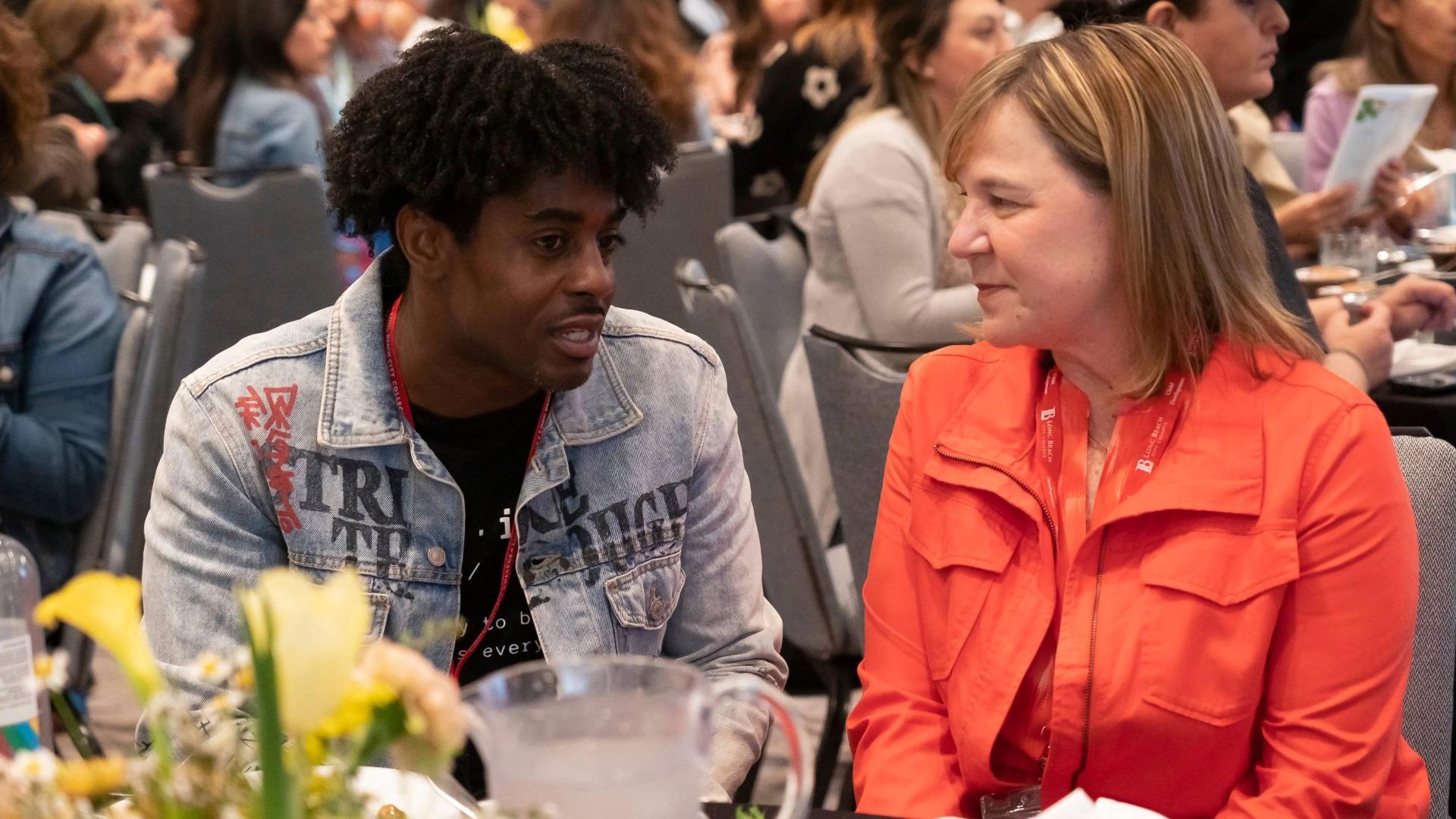 Jill Baker, right, talks to a student