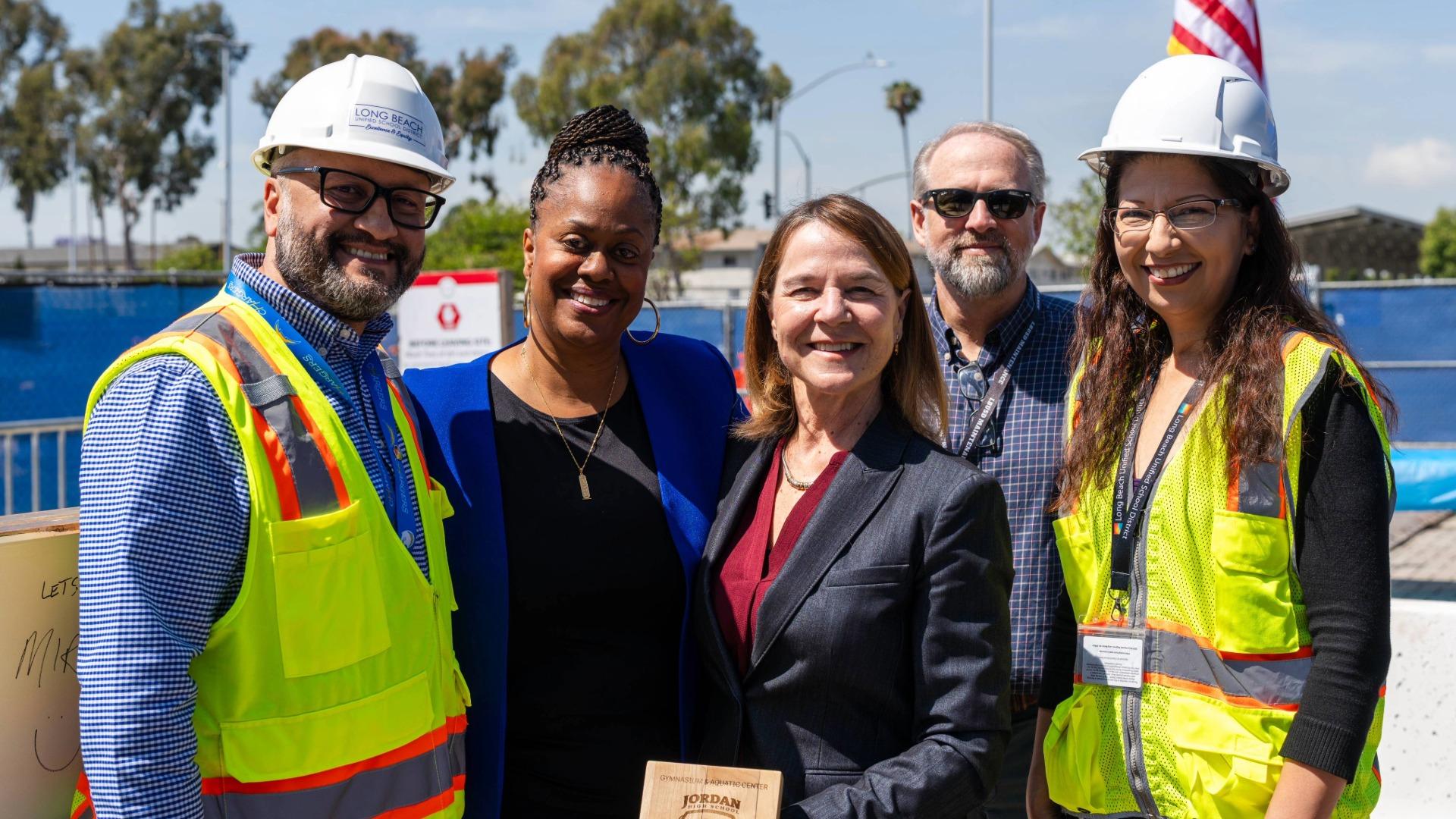 Jill Baker, center, stands with colleagues in hard hats