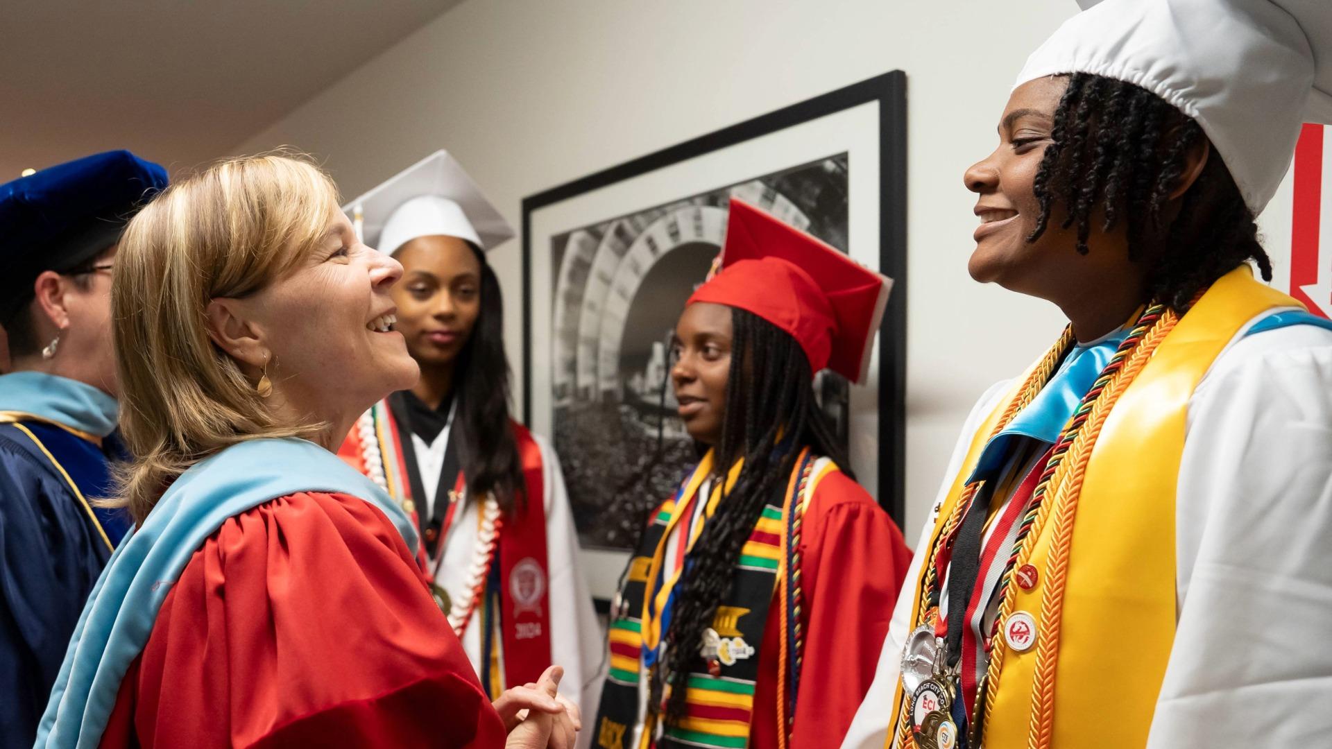 Jill Baker, left, in graduation regalia