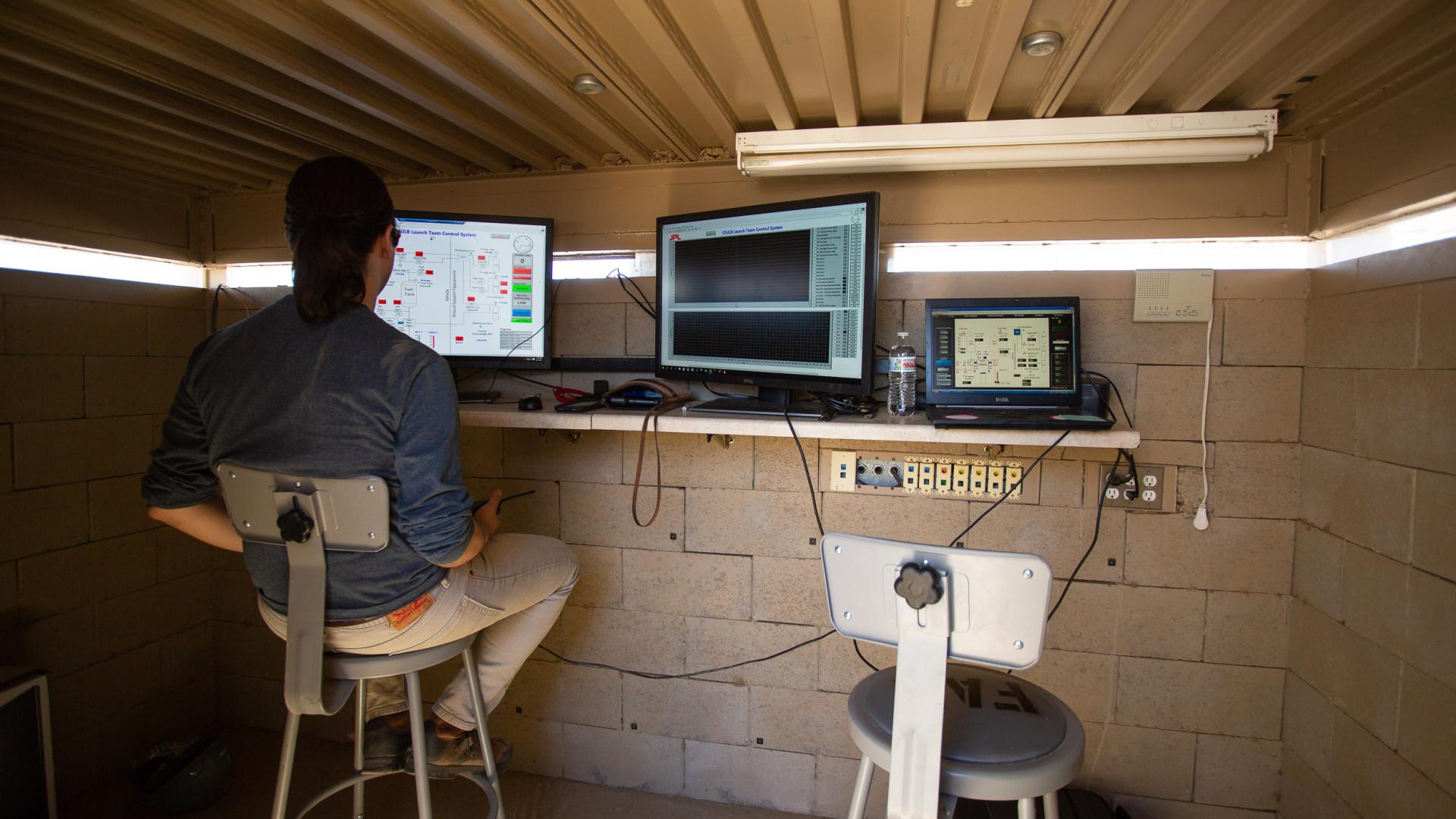 Behind the scenes, a member of the Beach Launch Team keeps an eye on computer calculations.