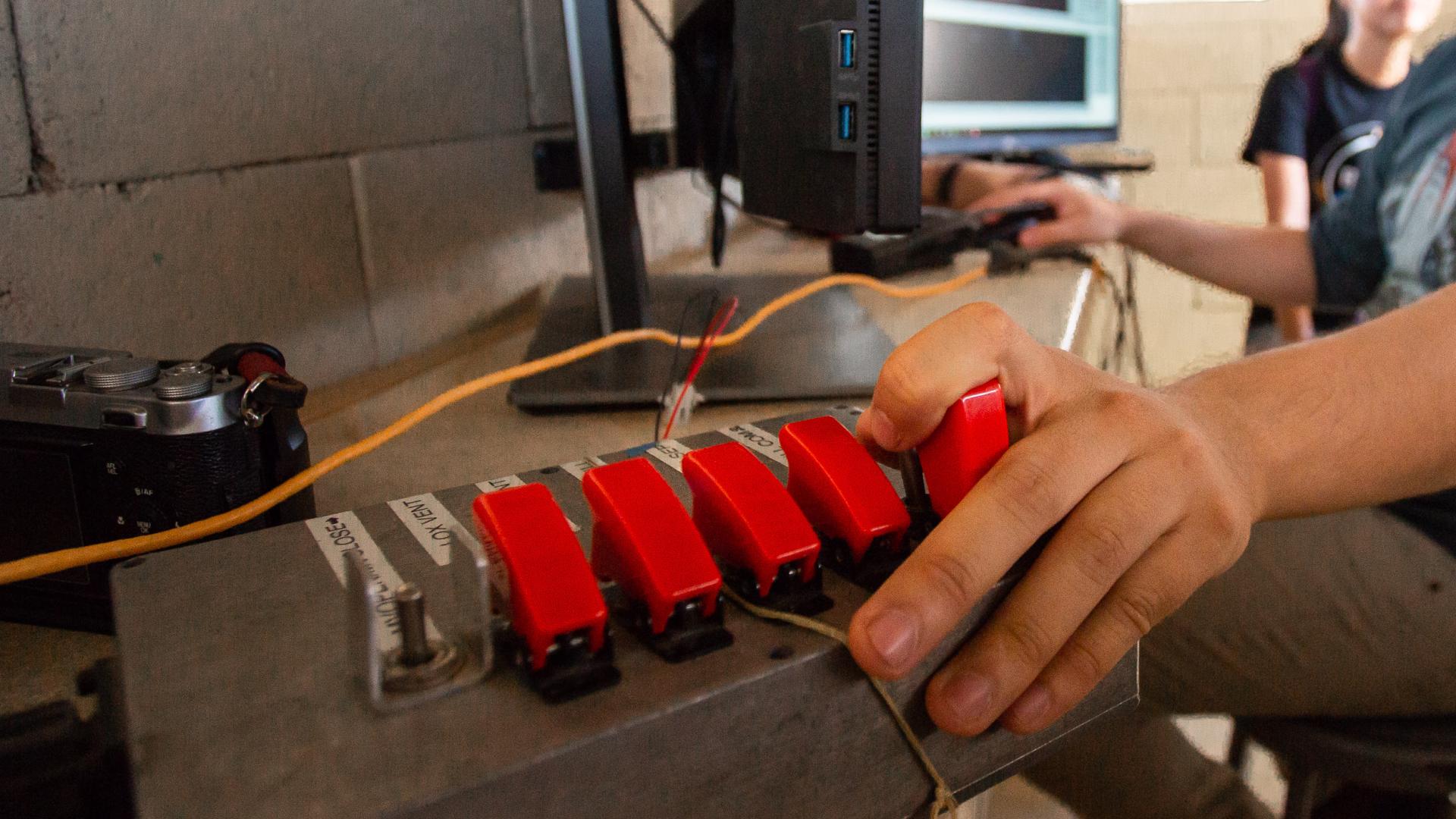 A switch ignites heat to a wire that carries a current to the rocket. 