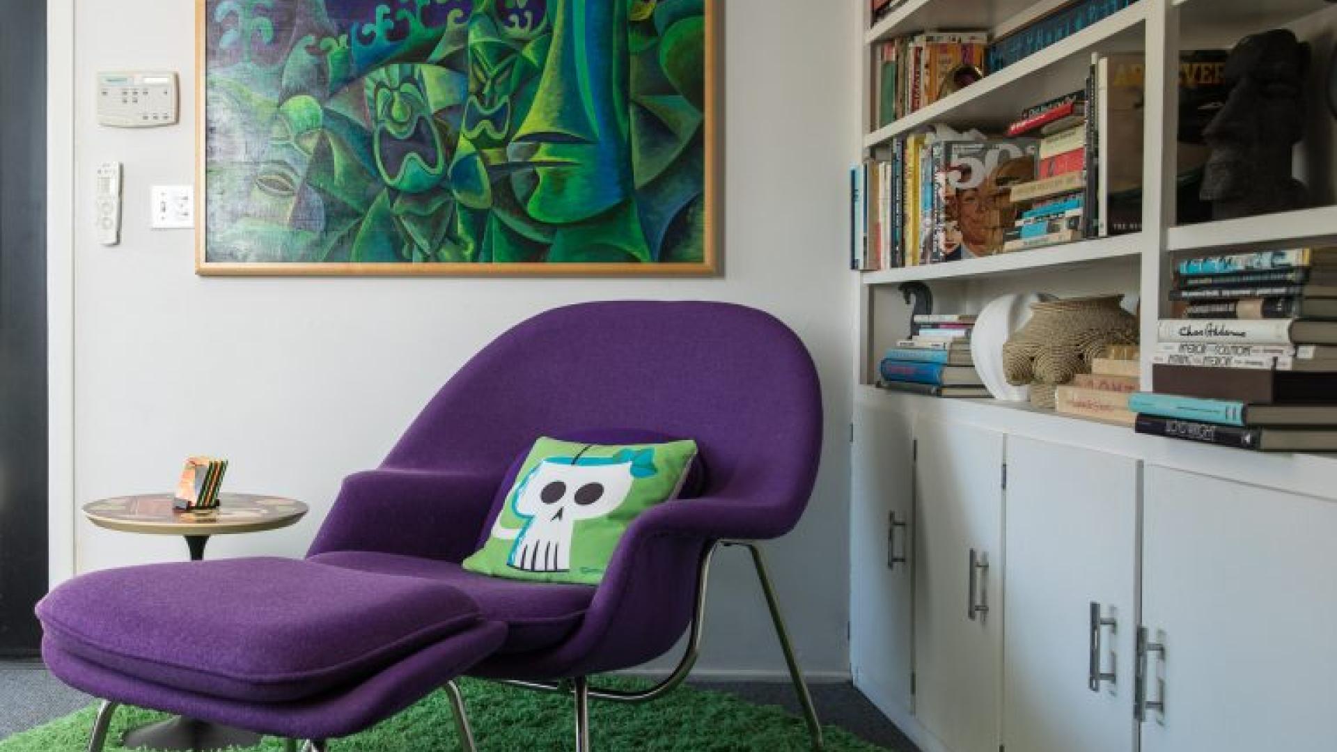 Purple chair and artistic green and blue Tiki painting