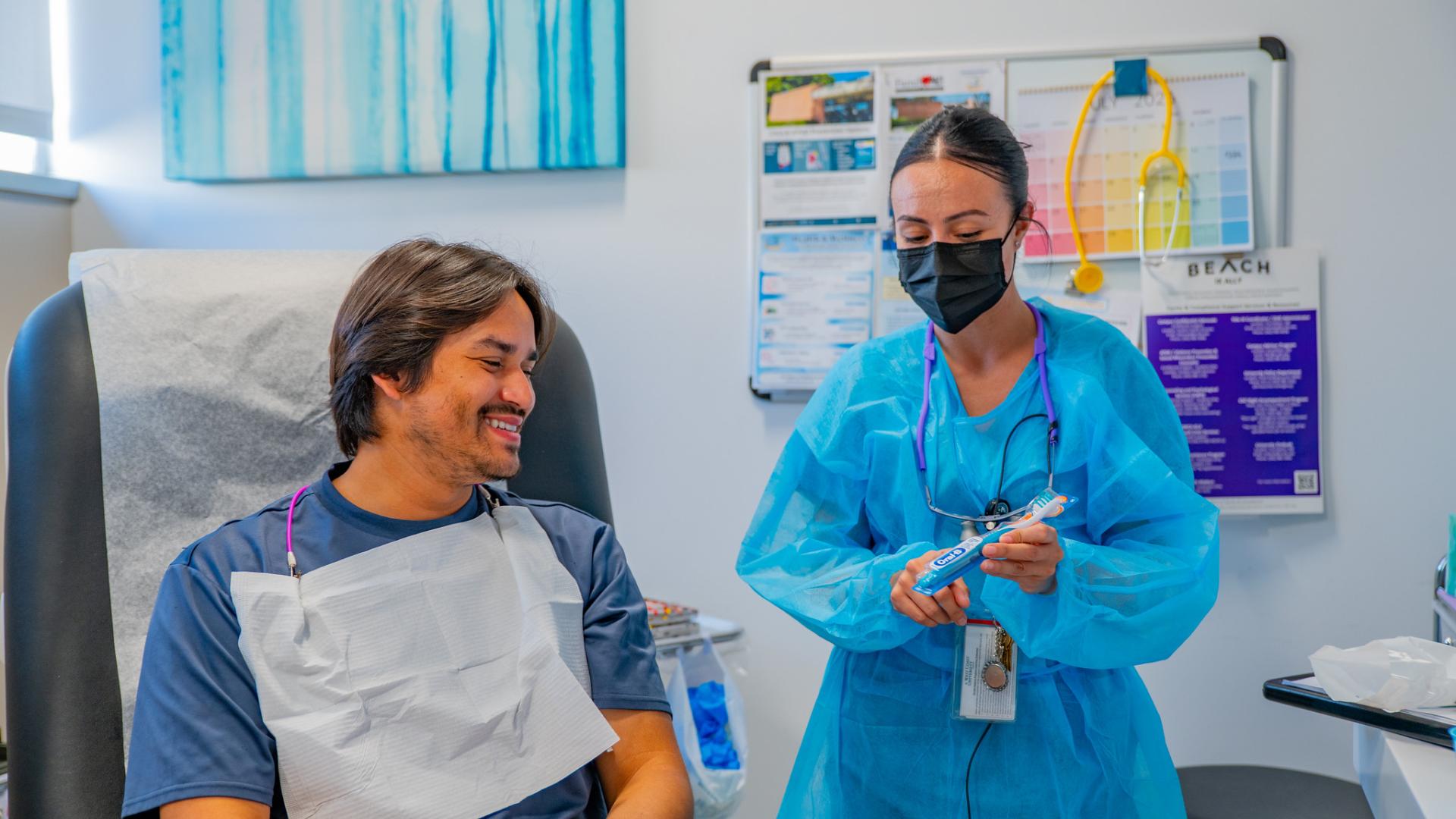A dentist explaining to a student.