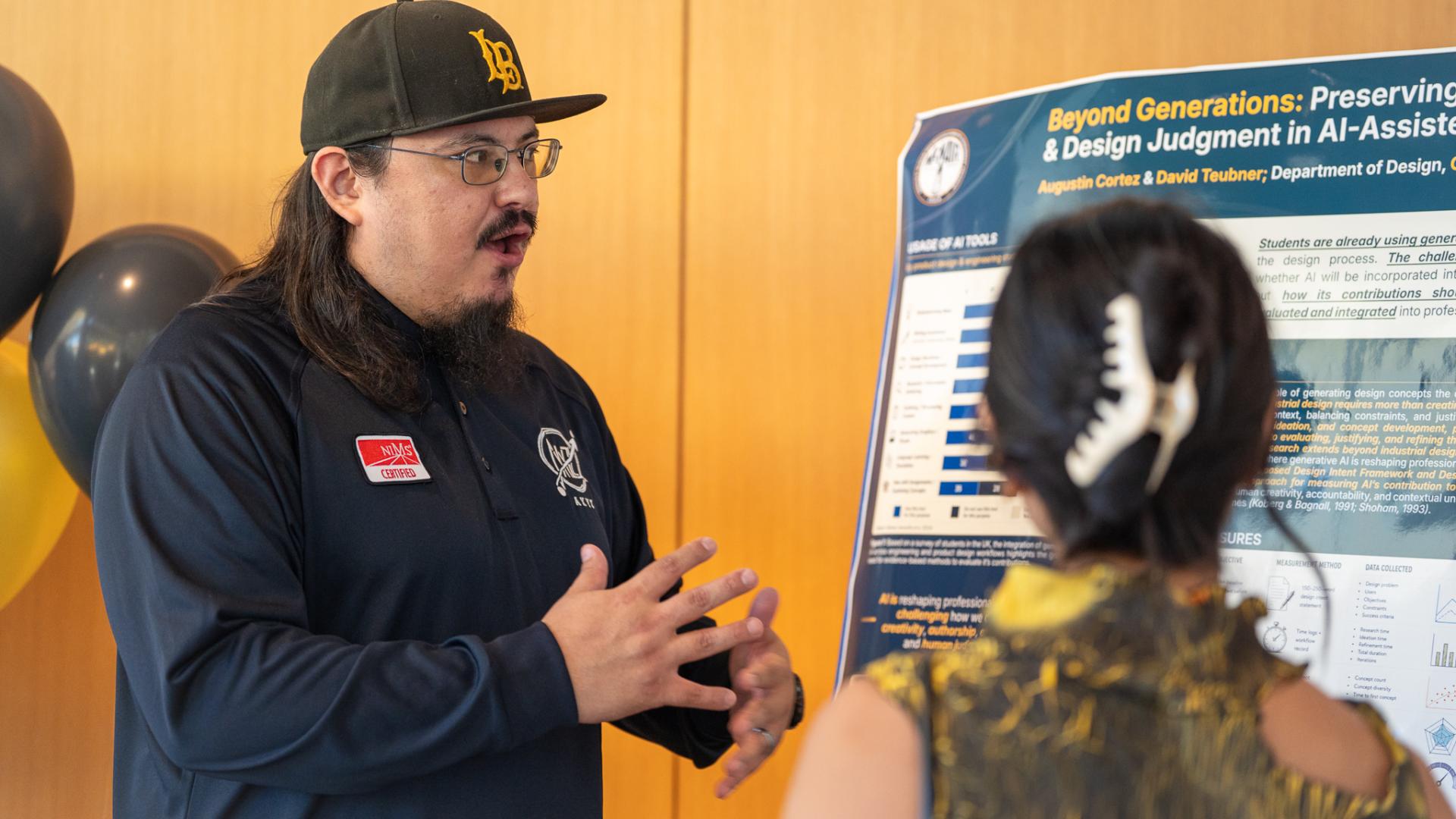 McNair Scholar Augustin Cortez discussing his research poster