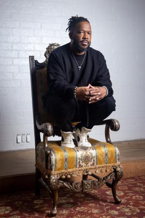 Phillip Boutte Jr. Phillip Boutte Jr. crouches on a chair