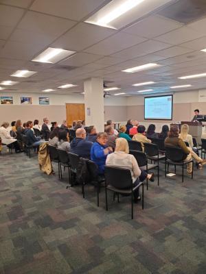 Seated audience listening to a speaker