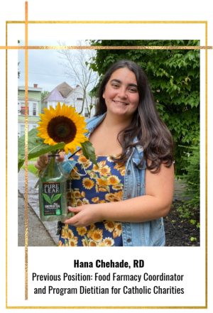 Woman smiling and holding a sunflower