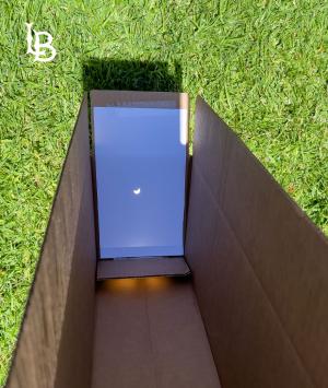 Partial solar eclipse as viewed through hole in a cardboard box Partial solar eclipse as viewed through hole in a cardboard box