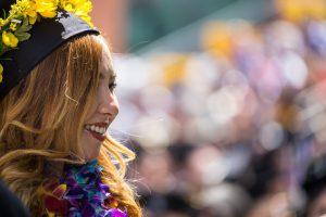 Linguistics Minor Side profile of a woman smiling and wearing a graduation cap.