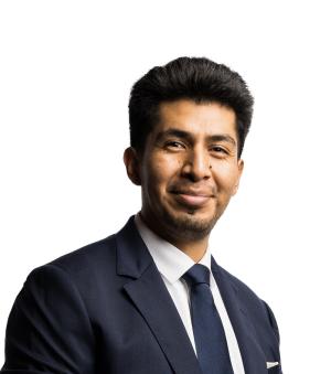 Alumnus Lance Santiago '19 wearing a suit jacket and tie