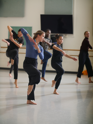 MFA student teaches a dance class in a large studio.
