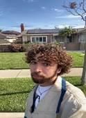 person in front of a house with grass