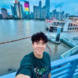 person standing by a harbor with a cityscape