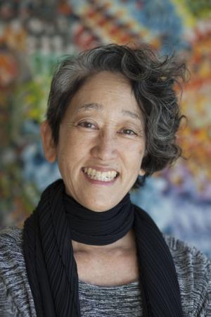 woman with black scarf against colorful background