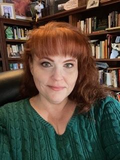 headshot in front of books