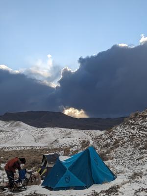 winter camping scene in a mountainous desert landscape