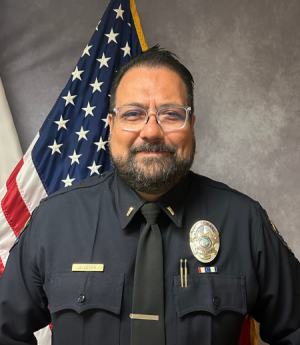 Lieutenant Leyva headshot in front of American flag.