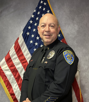 Lieutenant Sotelo headshot in front of American flag.