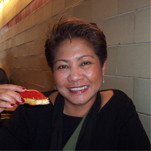 Smiling woman holding food.