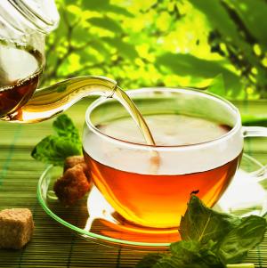 a cup of tea with a green background
