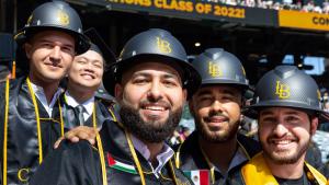 Group of male College of Engineering graduates wearing hard 