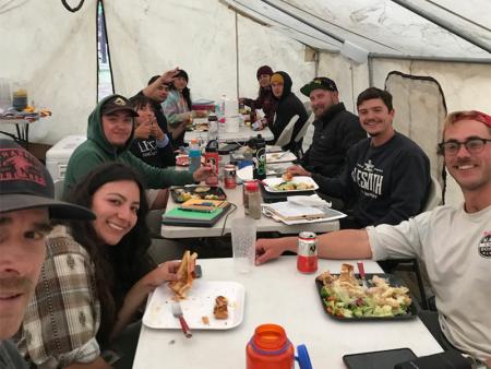 geology students enjoying lunch in a large tent