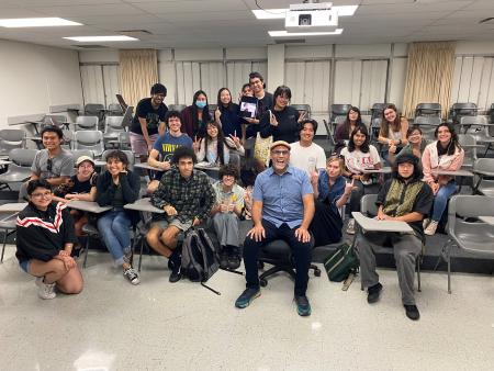 Animation students, professor sit in classroom