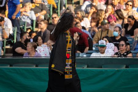 Student waves at Commencement crowd