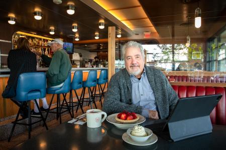 Alumn Craig Hoffman sits at restaurant table