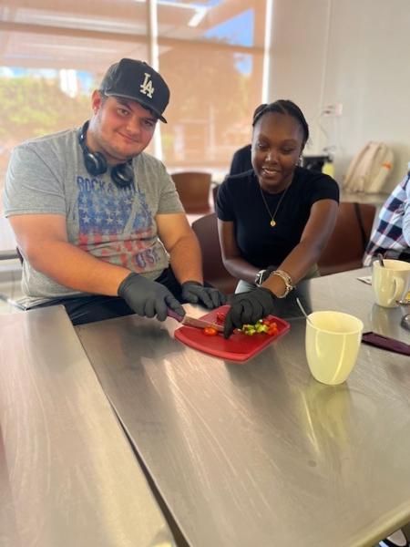 Students in Think Beach cut vegetables in a cooking class.