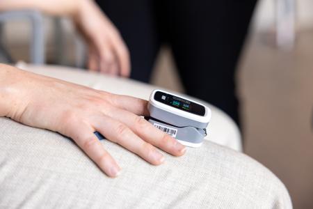 Student demonstrates oxygen monitor on her finger