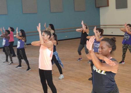 A group of dancers take class.