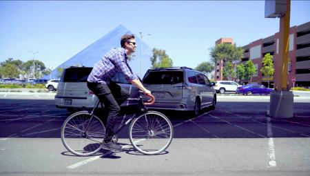 Man biking past Walter Pyramid