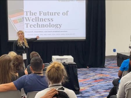 Dr. Michelle Alancar presenting on the future of wellness technology