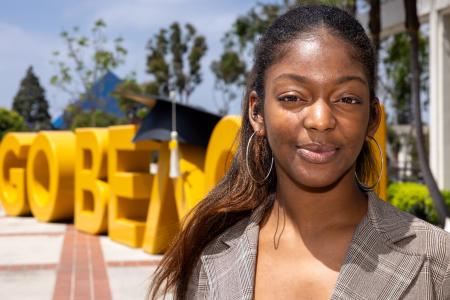 Chloe Thomas, an inaugural recipient of the Black Student Success Scholarship, with "Go Beach" letters in background