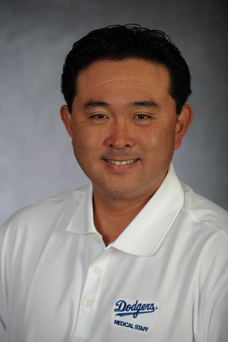 A portrait of Yosuke Nakajima '05 in a white polo shirt with the Dodgers logo in blue A portrait of Yosuke Nakajima '05 in a white polo shirt with the Dodgers logo in blue