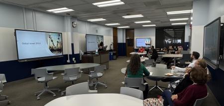 Zamarano Book Signing Event classroom with screens and people at tables