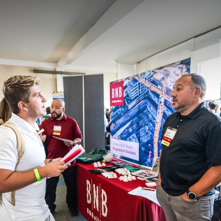A student and representative of BNB speak at a reverse job fair organized by CSULB. A student and representative of BNB speak at a reverse job fair organized by CSULB.