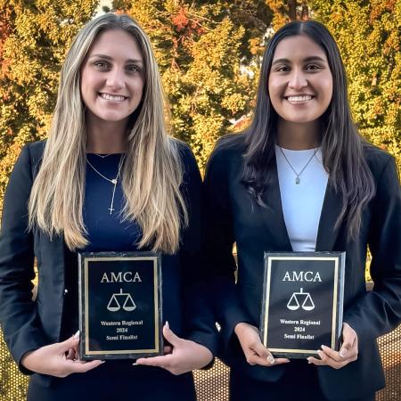 Two students hold AMCA plaques