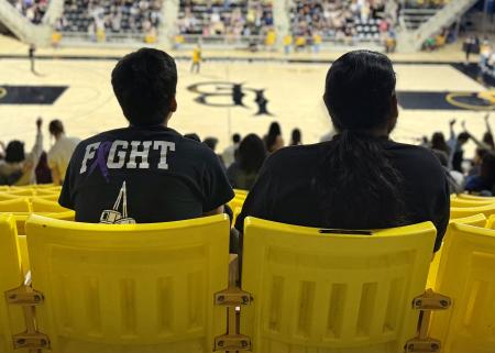 Two people sit in yellow seats in the Pyramid